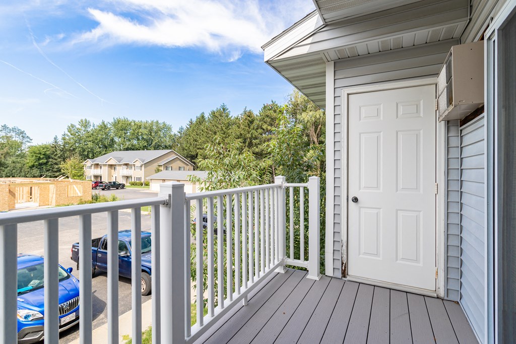 the view from the deck of a house with a white door