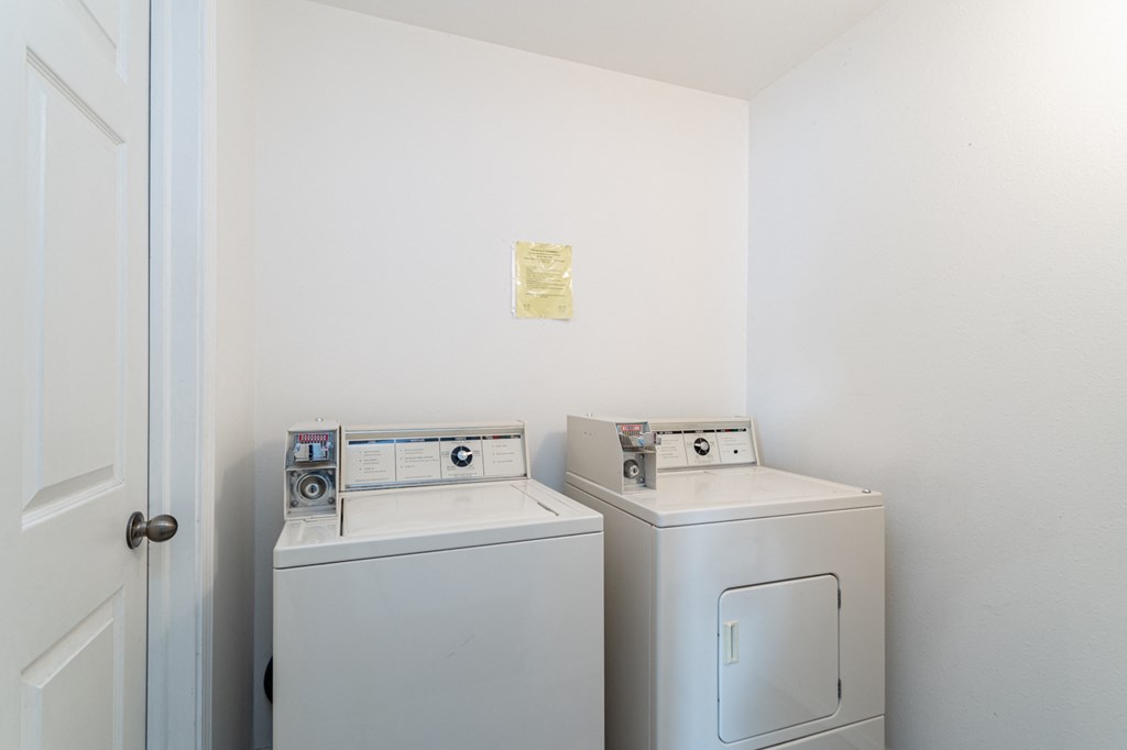 a laundry room with two washes and a dryer