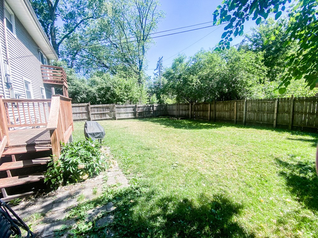 a backyard with a fenced in yard and a wooden fence