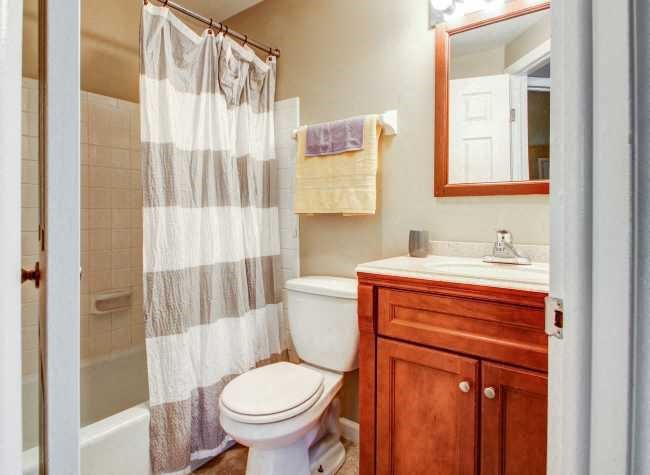 a bathroom with a toilet and a sink and a shower