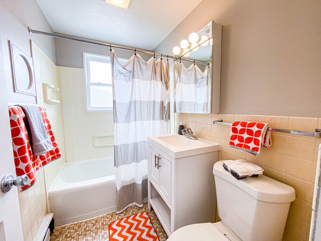 a bathroom with a shower toilet and sink and a bath tub