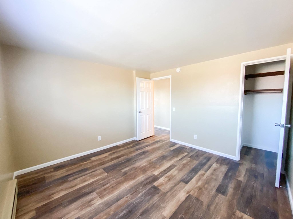 a living room with wood flooring and a closet