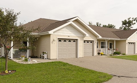A two-story house with a garage on the side.