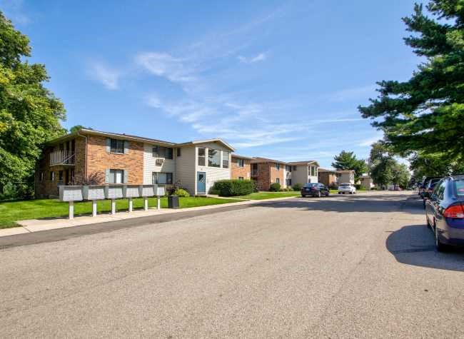 a street with cars parked in front of houses