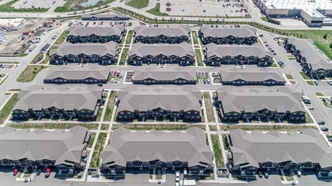 an aerial view of a row of houses in a parking lot
