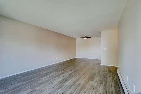 A room with a wooden floor and a ceiling fan.