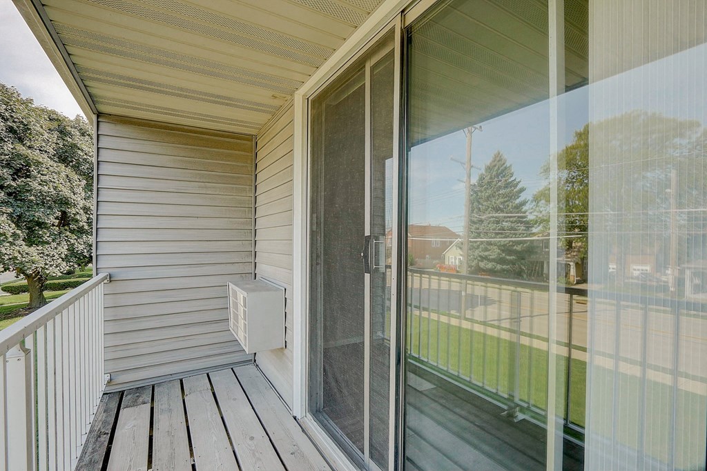 a sliding glass door on a porch of a home