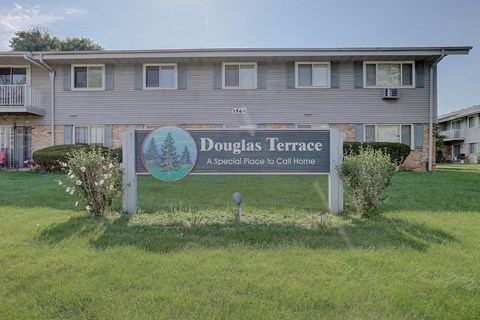A sign for Douglas Terrace in front of a building.