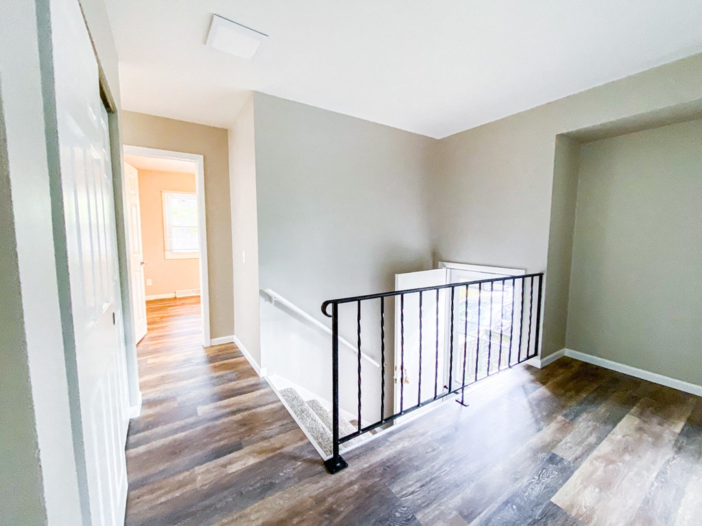 a view of the top of a staircase in a home with wood flooring