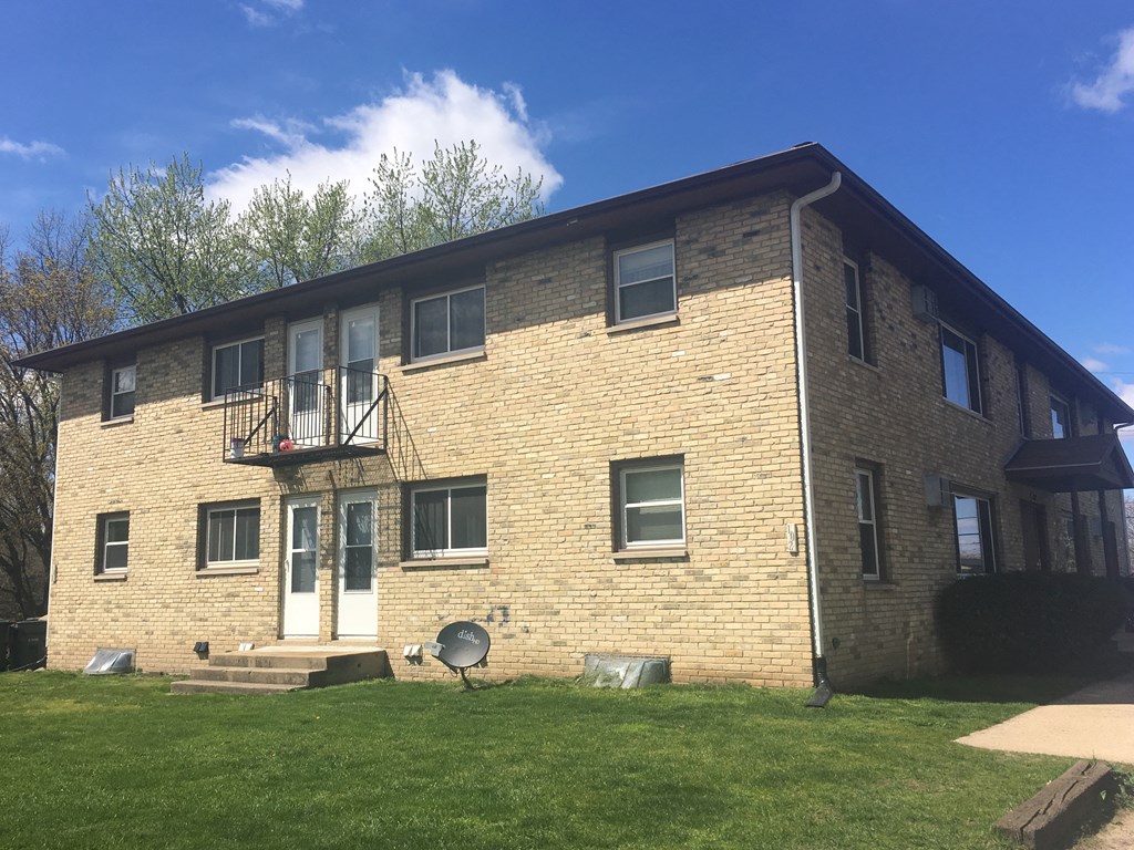 a brick apartment building with a blue sky in the background