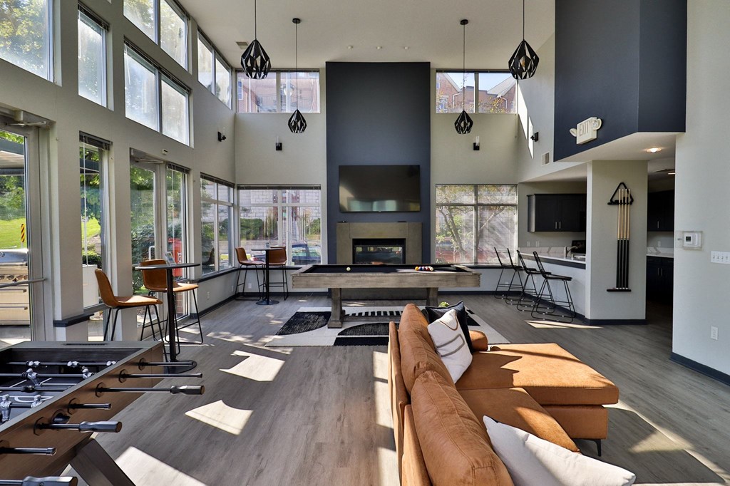 a large living room with couches and chairs and a fireplace