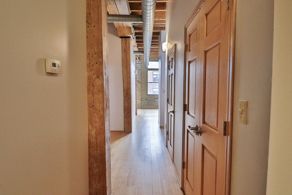 a hallway with wooden doors and a wood floor