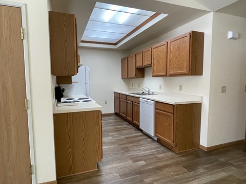 A kitchen with wooden cabinets and a white fridge.