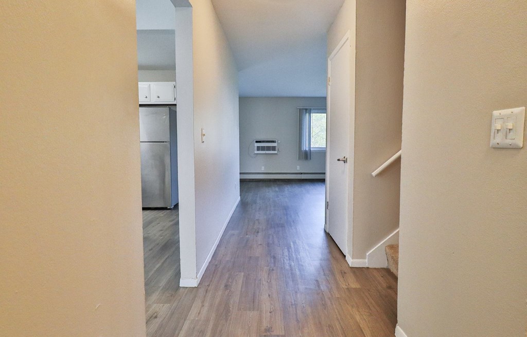 a view of a living room and kitchen with wood floors