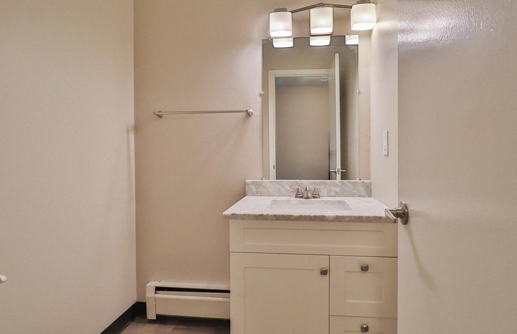 a small bathroom with a sink and a mirror