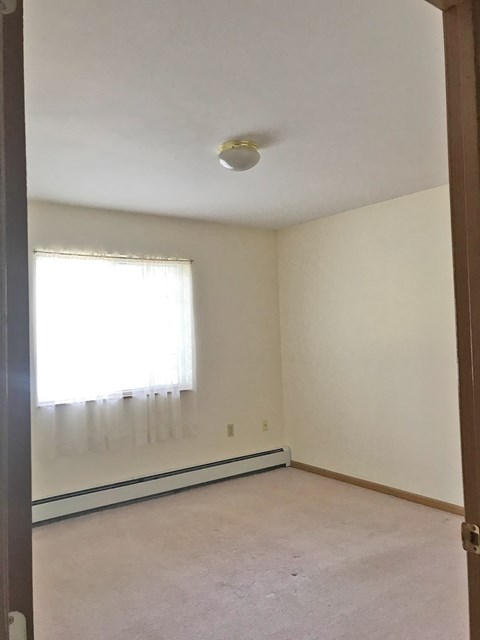 A room with a window and a ceiling light.