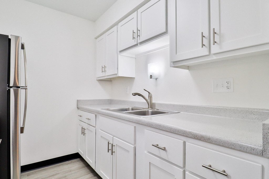 the preserve at ballantyne commons apartment kitchen with sink and refrigerator
