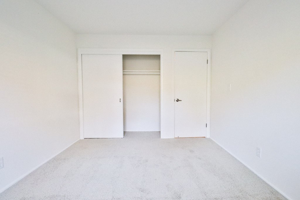 an empty room with white walls and white doors