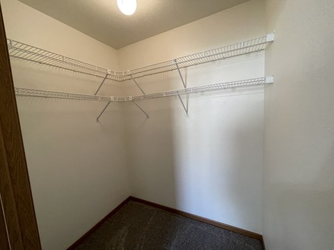 Empty white shelves in a room.
