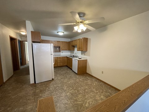 A kitchen with a refrigerator, microwave, and oven.