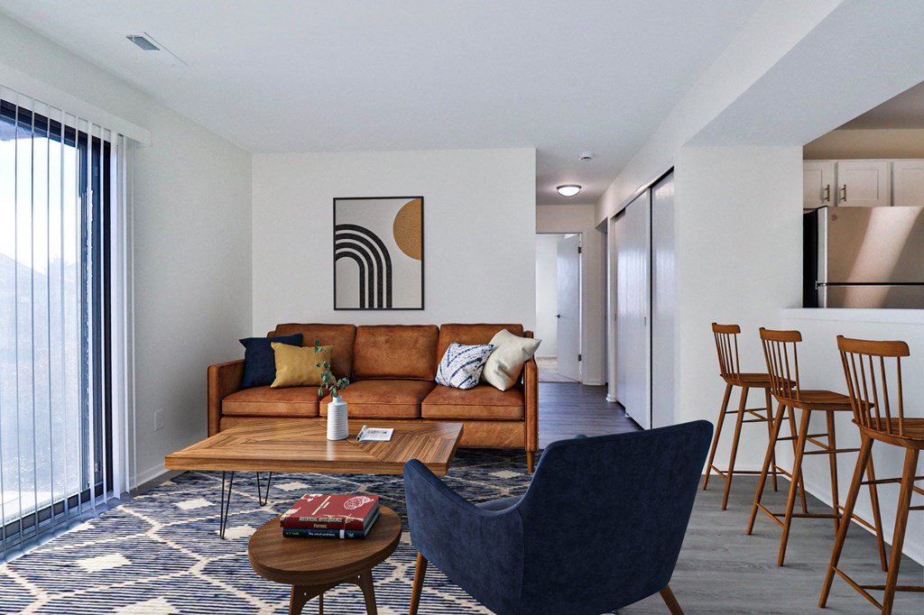 A living room with a blue chair and a brown sofa.
