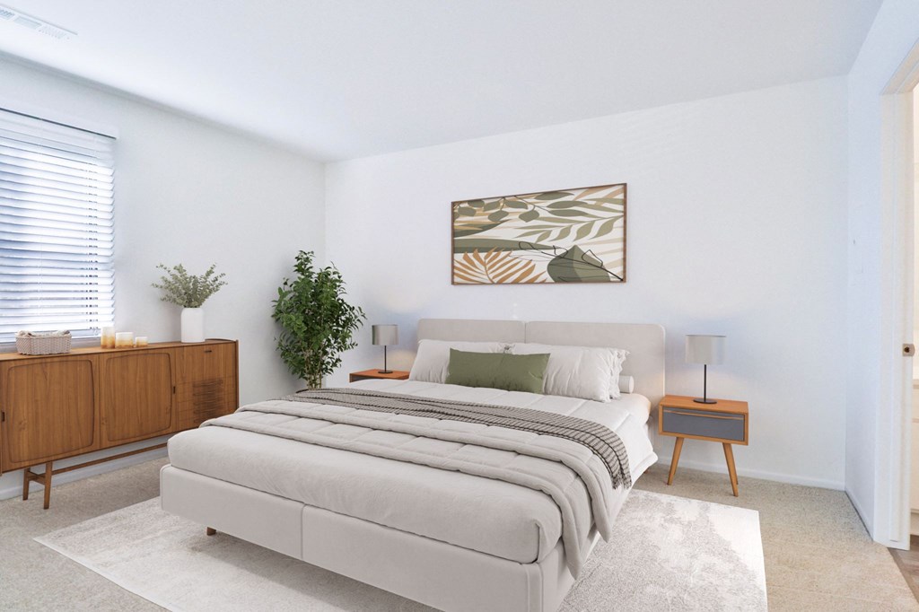 A bedroom with a large bed, a wooden cabinet, and a framed picture on the wall.