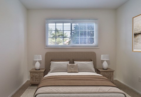 A bedroom with a large bed and two lamps on either side.