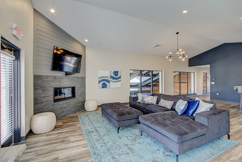 a large living room with a large couch and a large tv on the wall