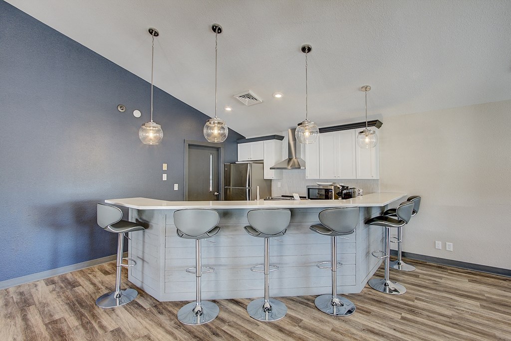 a kitchen with an island and stools