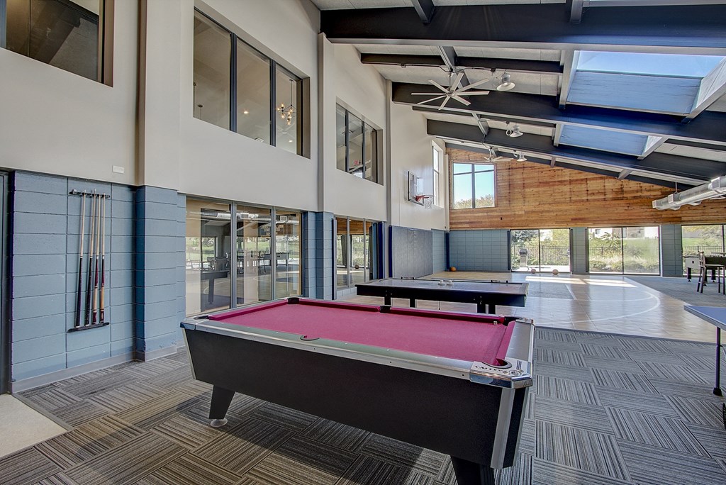 a pool table and ping pong table in the games room