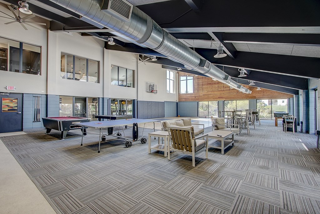 a game room with a ping pong table and a foosball table