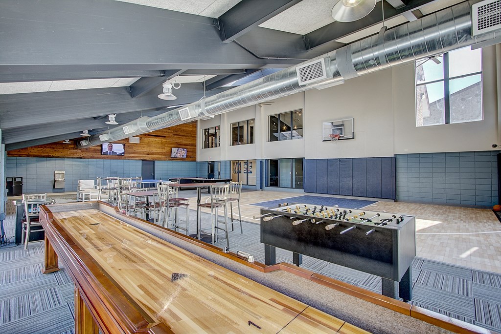 a large room with a foosball table and ping pong table