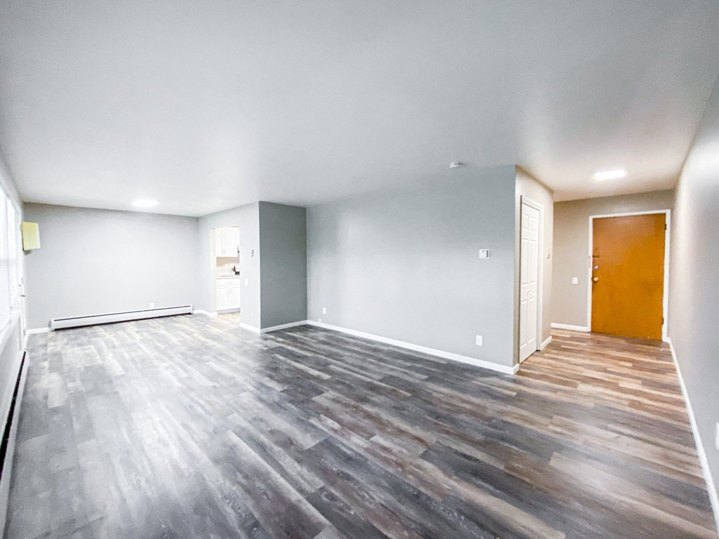 the living room of a new home with wood flooring