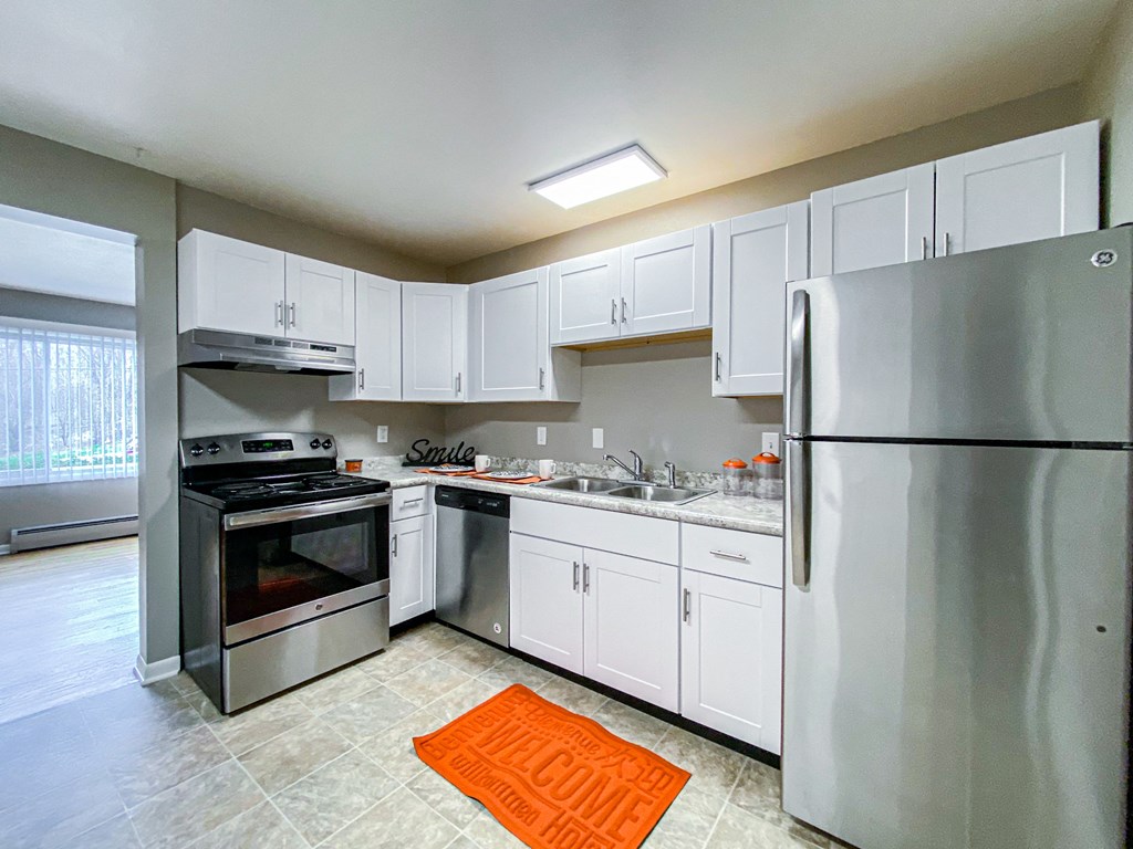 a kitchen with stainless steel appliances and white cabinets
