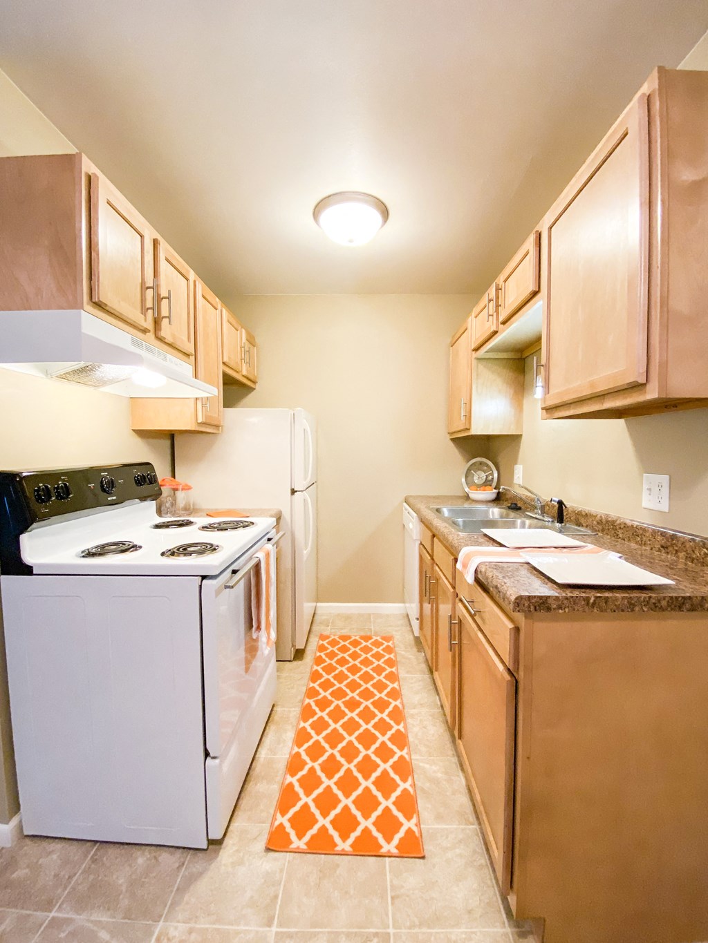 a kitchen with a stove refrigerator and sink
