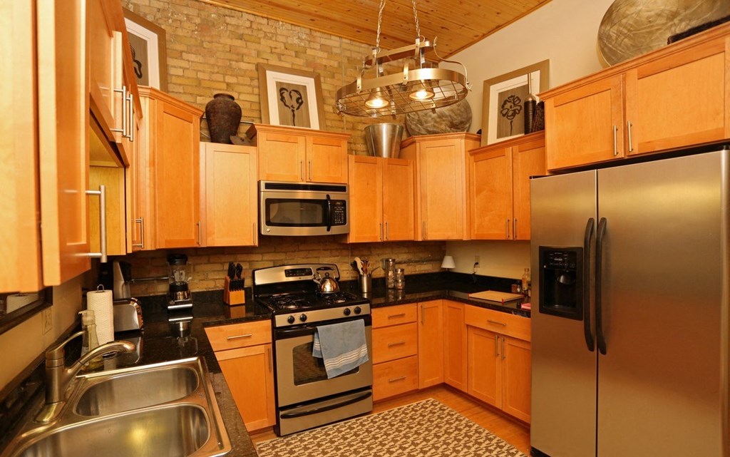 a kitchen with stainless steel appliances and wooden cabinets