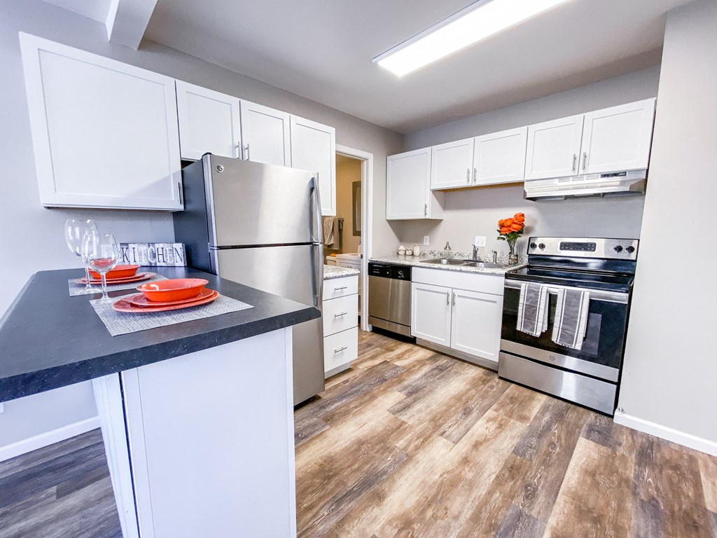 a kitchen with stainless steel appliances and white cabinets