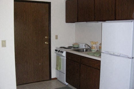 a small kitchen with a stove and a refrigerator