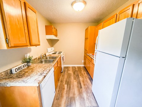 a kitchen with wooden cabinets and a white refrigerator