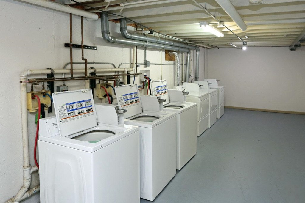a row of washing machines in a laundromat
