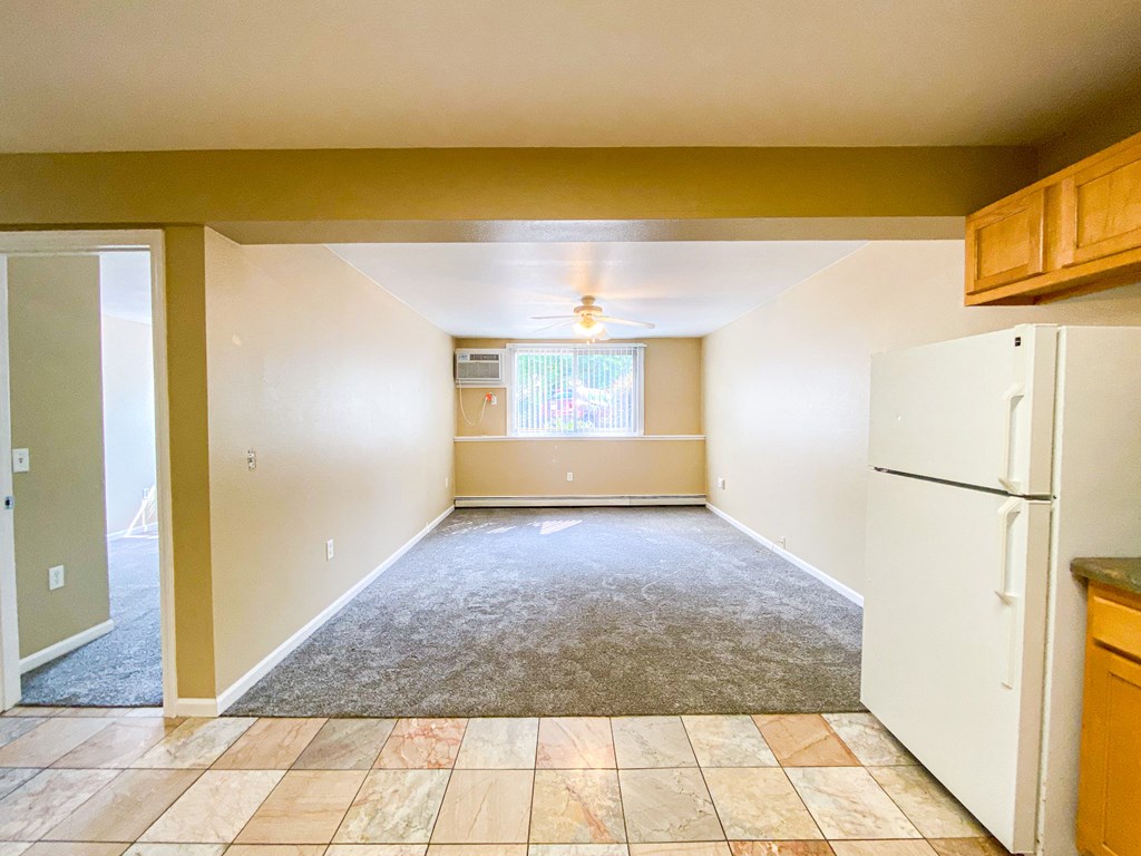 a empty kitchen with a refrigerator and a sink