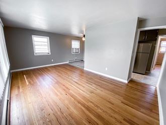 an empty living room with wood flooring in a new home