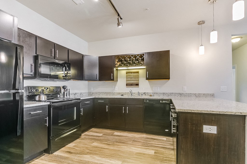 a kitchen with black cabinets and a white counter top