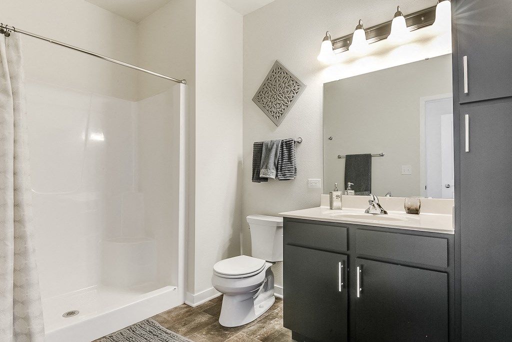 a bathroom with a toilet sink and shower