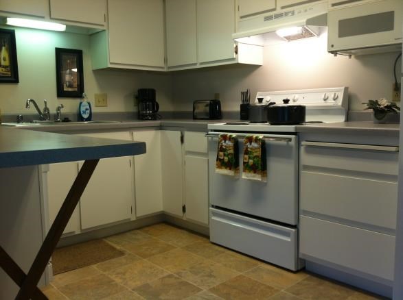 A kitchen with a white oven and a blue counter.