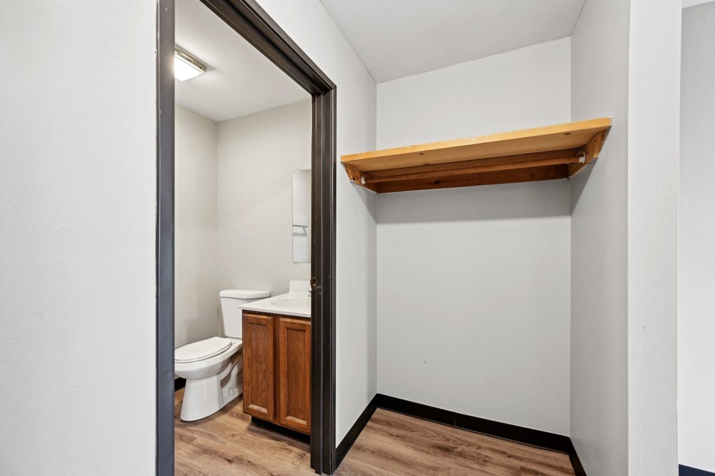 a bathroom with a toilet and a mirror