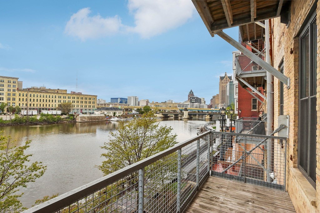 the view of the river from the balcony of a building with a balcony railing