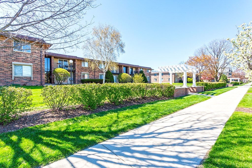 a row of houses with a sidewalk in front of them