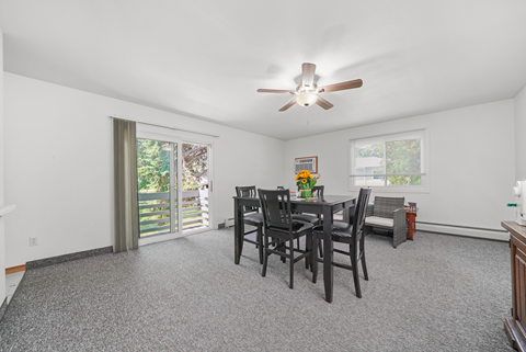 A dining room with a table set for four.
