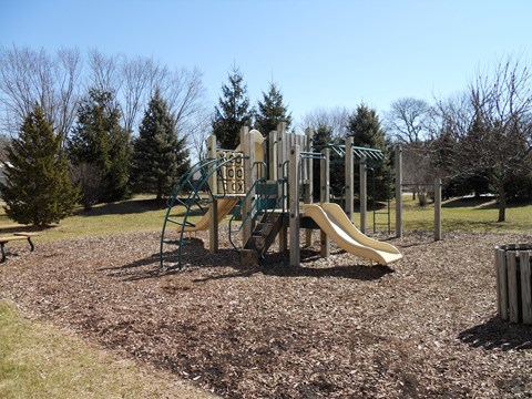 A playground with a slide and a climbing frame.